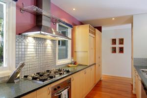 a kitchen with a stove top oven next to a window at A Perfect Stay - Abode at Byron in Ewingsdale