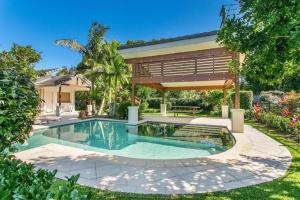 a swimming pool in the backyard of a house at A Perfect Stay - Amity at Seadrift in Byron Bay