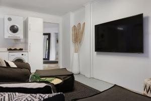 a living room with a flat screen tv on a wall at A Perfect Stay - Arya in Byron Bay