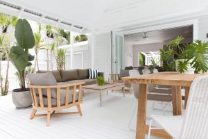 a living room with a table and a couch at Barrel & Branch in Byron Bay