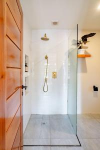 a bathroom with a shower with a glass door at Markisa Villas - Private Pool Villas on Gili Air in Gili Islands
