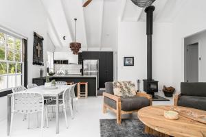 a kitchen and living room with a table and chairs at A Perfect Stay - Black Star in Byron Bay