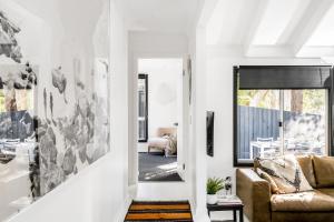 a living room with a couch and a window at A Perfect Stay - Black Star in Byron Bay