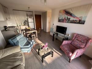 a living room with a couch and chairs and a table at Bella Lombarda in San Pedro de la Paz