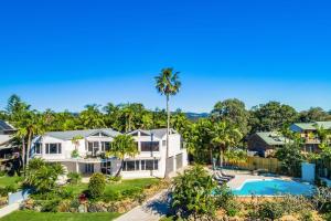 an aerial view of a house with a pool and palm trees at A Perfect Stay - Byron Pacific Vista in Byron Bay