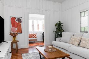 a living room with a couch and a table at A Perfect Stay - Cape Cottage in Byron Bay