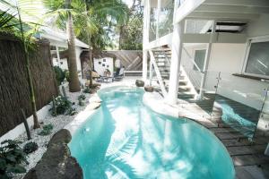 a swimming pool in the backyard of a house at A Perfect Stay - Cactus Rose Villa in Byron Bay