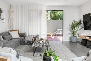 a living room with a couch and a table at A Perfect Stay - Catalinas in Byron Bay