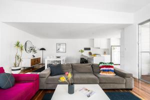 a living room with two couches and a pink couch at A Perfect Stay - Clique 1 in Byron Bay