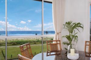 a dining room with a view of the ocean at A Perfect Stay - King Tide in Gold Coast