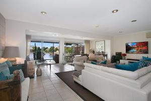 a living room with white couches and a tv at A Perfect Stay - La Casetta in Gold Coast