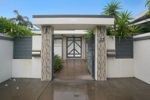 a front door of a house with palm trees at A Perfect Stay - La Casetta in Gold Coast