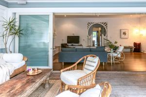 a living room with a couch and a table at A Perfect Stay - Kia Ora Byron in Byron Bay
