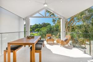 a dining room with a table and chairs on a patio at A Perfect Stay - Lisas on Lawson in Byron Bay