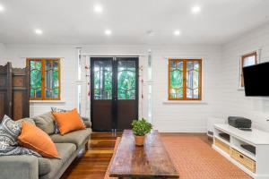 a living room with a couch and a coffee table at A Perfect Stay - Longhouse in Byron Bay