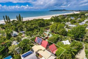 an aerial view of a beach with houses and trees at A Perfect Stay - Longhouse in Byron Bay