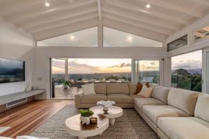a living room with a couch and a table at Miren Estate - lavish hinterland estate with pool in Federal
