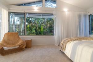 a bedroom with a bed and a large window at Miren Estate - lavish hinterland estate with pool in Federal +15 photos