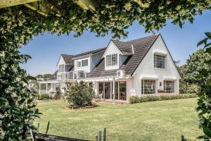 a large white house with a black roof at A Perfect Stay in Ewingsdale