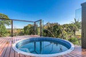 a swimming pool on a wooden deck with a view at A Perfect Stay - Ourmuli Cabin in Byron Bay