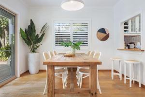 a dining room with a wooden table and chairs at A Perfect Stay - Pompano House Byron Bay in Suffolk Park