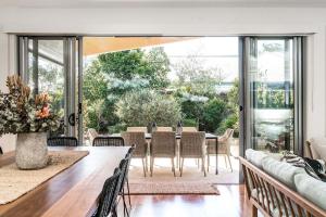 a dining room with a table and chairs at A Perfect Stay - Shore Beats Work in Suffolk Park