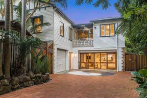 a large house with a driveway in front of it at Skye Lodge - 7 Bedroom charming Balinese retreat with designer pool in Byron Bay