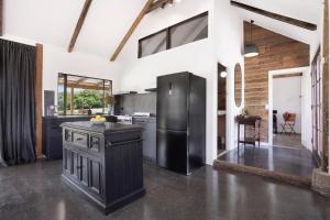 a large kitchen with a black refrigerator in a room at A Perfect Stay - The Dairy Nashua in Nashua