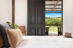 a room with a bed and a door with a view at A Perfect Stay - The Dairy Nashua in Nashua