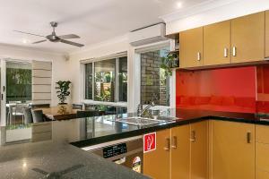 a kitchen with a sink and a counter top at A Perfect Stay - Tradewinds 4 in Bangalow