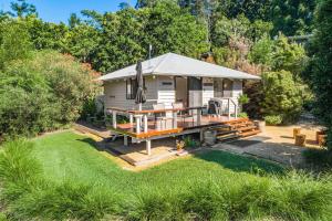 a tiny house with a porch and a deck at Twin Tallows - secluded couples retreat in Bangalow