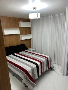 Кровать или кровати в номере Apartamento no vitória LOFT