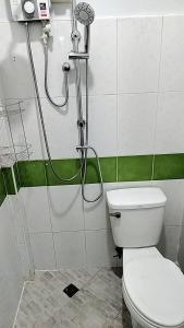 a bathroom with a shower with a toilet in it at CS Apartment in Vientiane