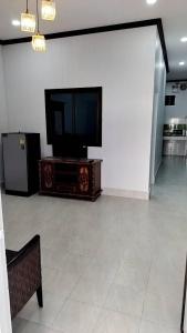 a living room with a flat screen tv on a entertainment center at CS Apartment in Vientiane