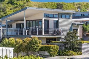 a large house with a large balcony in front at A Perfect Stay - Sandy Feet in Lennox Head