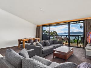 a living room with a couch and a table at Stockyards 3 - Jindabyne Luxury Townhouse in Jindabyne