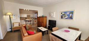 a living room with a couch and a table at Broken Hill Outback Church Stay in Broken Hill