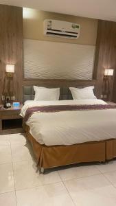 a large bed in a hotel room with at Lavender Hotel in Taif