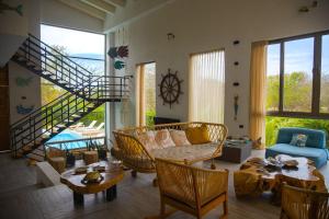 a living room with a staircase and a table and chairs at Casa privada en Isla Barú 5BR in Baru