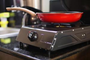a red pot sitting on top of a stove at El Hogar II in Kiambu