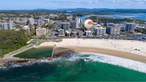 an aerial view of a beach and a city at El Sandi 1 in Forster