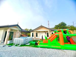 a house with an inflatable playground in a yard at AA SWEET ROOM TANJUNG BIDARA MELAKA in Masjid Tanah