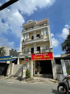 a white building with a red sign in front of it at QUỲNH HOA HOTEL in Ho Chi Minh City