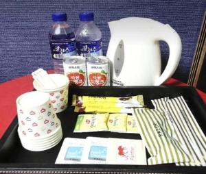 a tray with cups and other items on a table at Paldo Motel in Yeosu