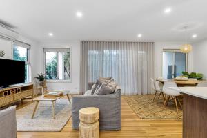 a living room with a couch and a table at A Perfect Stay - Drift in Byron Bay