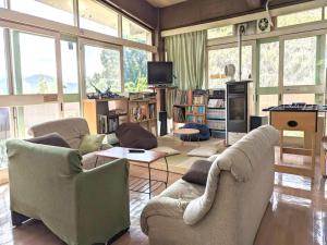 a living room with two couches and a tv at Amanohashidate Youth Hostel - Vacation STAY 94808v in Miyazu
