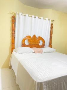 a bed with a wooden headboard in a bedroom at PINE VALLEY ESTATES 9b BALCONY VIEW TWO BEDROOM 2 BATHROOMS 