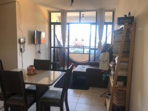 een eetkamer met een tafel en een raam bij Quarto privativo in Campina Grande