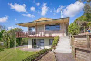 a house with a balcony and a fence at Spacious with fabulous views overlooking the city in Hamilton