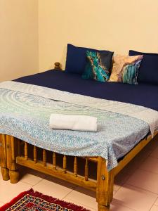 a bed in a room with a towel on it at Paradise Inn Beach Resort in Varkala